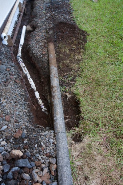 The pipe is glued together all the way up until where the Y will go, and the trench has been partially filled back so the pipe has support.