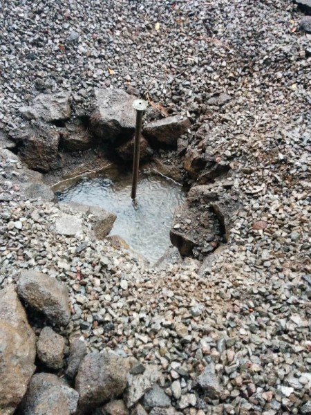 This is the mysterious sprinkler, ascending from the concrete-lined pit. At this point the water level was already rising from the rain.