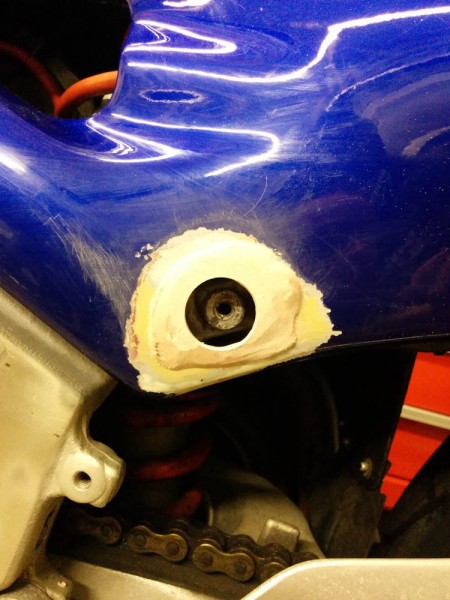 With the fairing on the bike, the location of the hole was measured and a 1-inch hole drilled. 