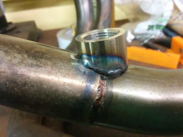 The first bung is tacked in place. I also had to weld on some material where it was initially too short.