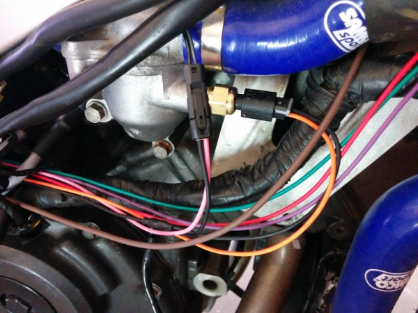 The new wires for the harness. The tiny connector in front of the thermostat is for the intake air temp sensor, Behind it is the new 2-wire coolant temp sensor. Three wires continue up to the temp gauge.