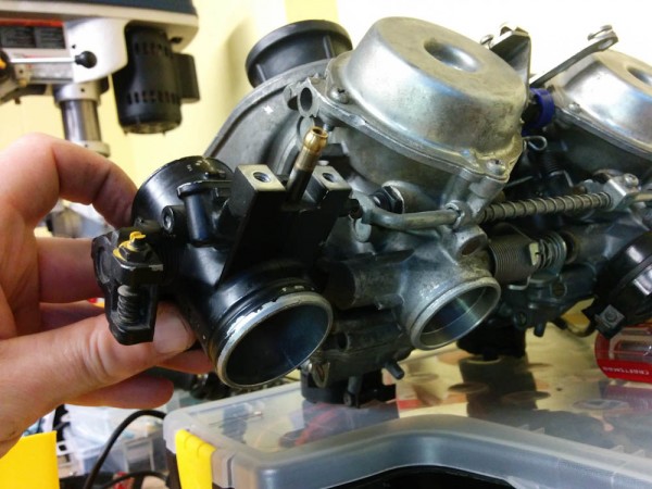 The GPz1100 throttle body on the left vs the NC30 carb on the right. The bore and general size are pretty close.