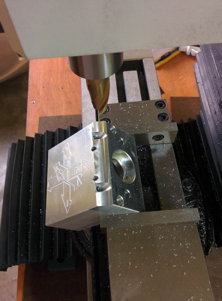 The "1D milling" down of the Y-axis motor mounting plate. Since I could do this by just running an endmill back and forth, I just locked the Y-axis gibs in place and typed G-code manually to run the table back and forth. A bit primitive, but it worked. 