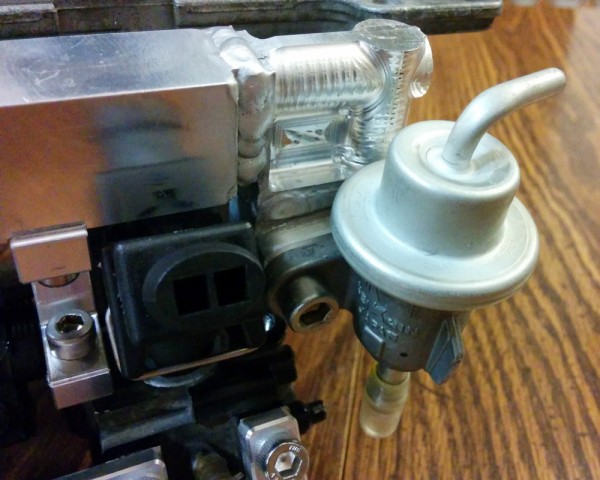 A closeup of the fuel pressure regulator and the injector for cylinder 3. It's tight, but everything should fit.