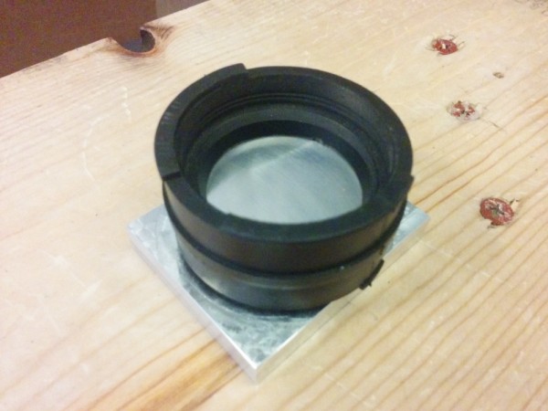 Here's one of the intake rubbers snapped into the fixture. At this point, it can be clamped with the stock clamps.
