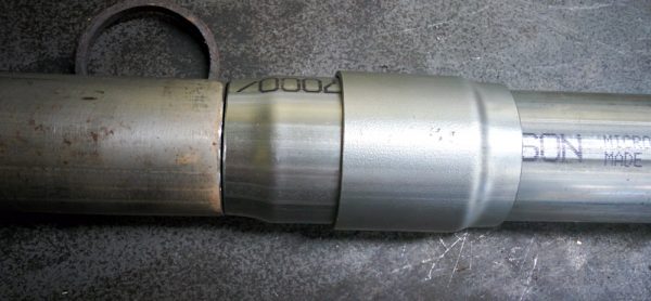 One of the double-slip couplings. The part on the left is slightly expanded and slides in between the pipe on the right and the outer collar, which gets welded to the pipe.