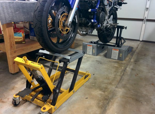 With the front wheel jacked up by the bike lift and the rear wheel elevated by putting the stand on the car ramps, it's much easier to access the exhaust system.